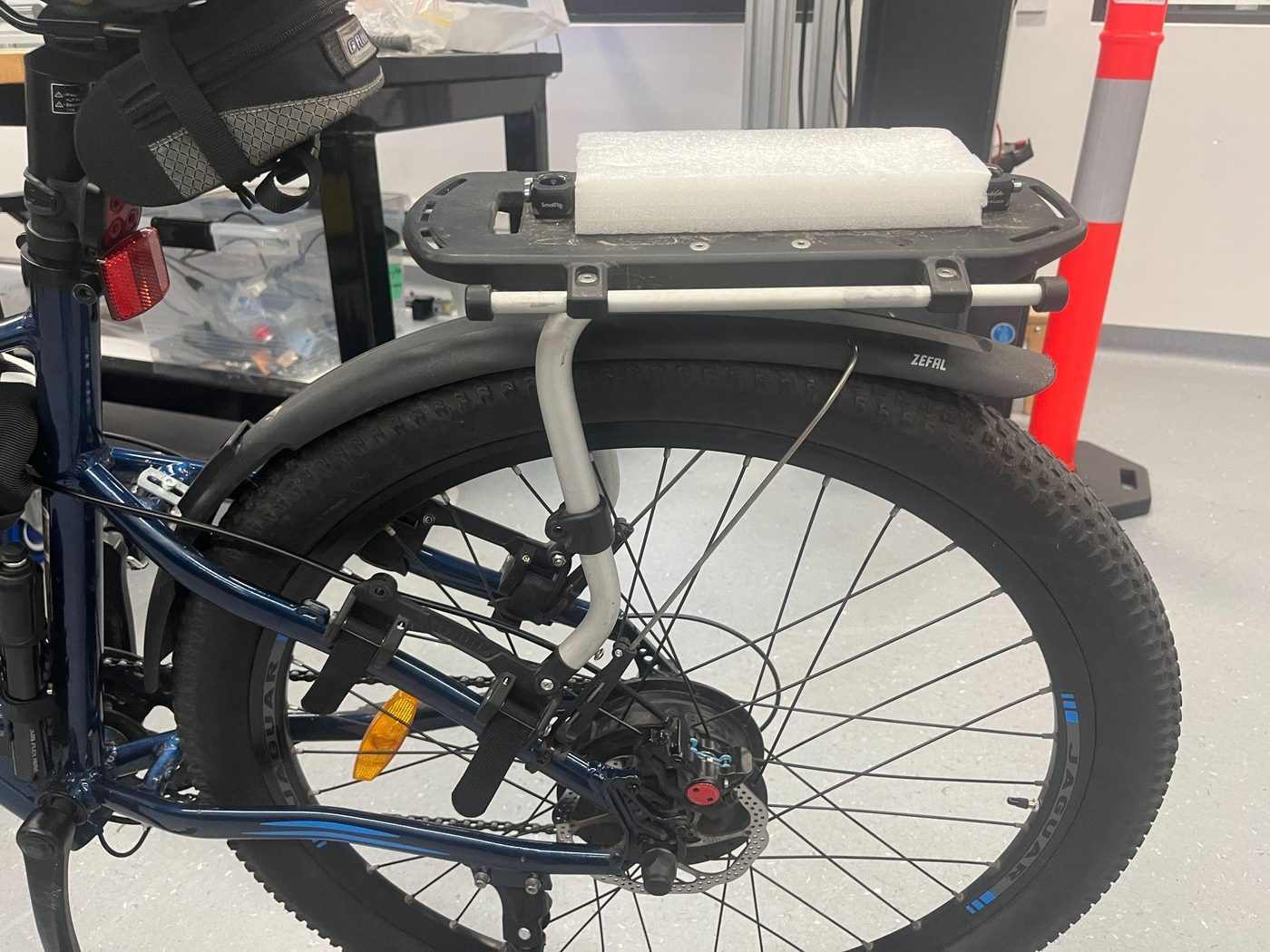 Frame attached to the rear rack of the bike